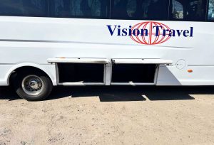 Side view of 29/25 Seater Vehicle with large side luggage compartment open