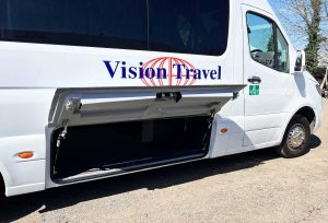 Side view of 22/19 Seater Vehicle with large side luggage compartment open